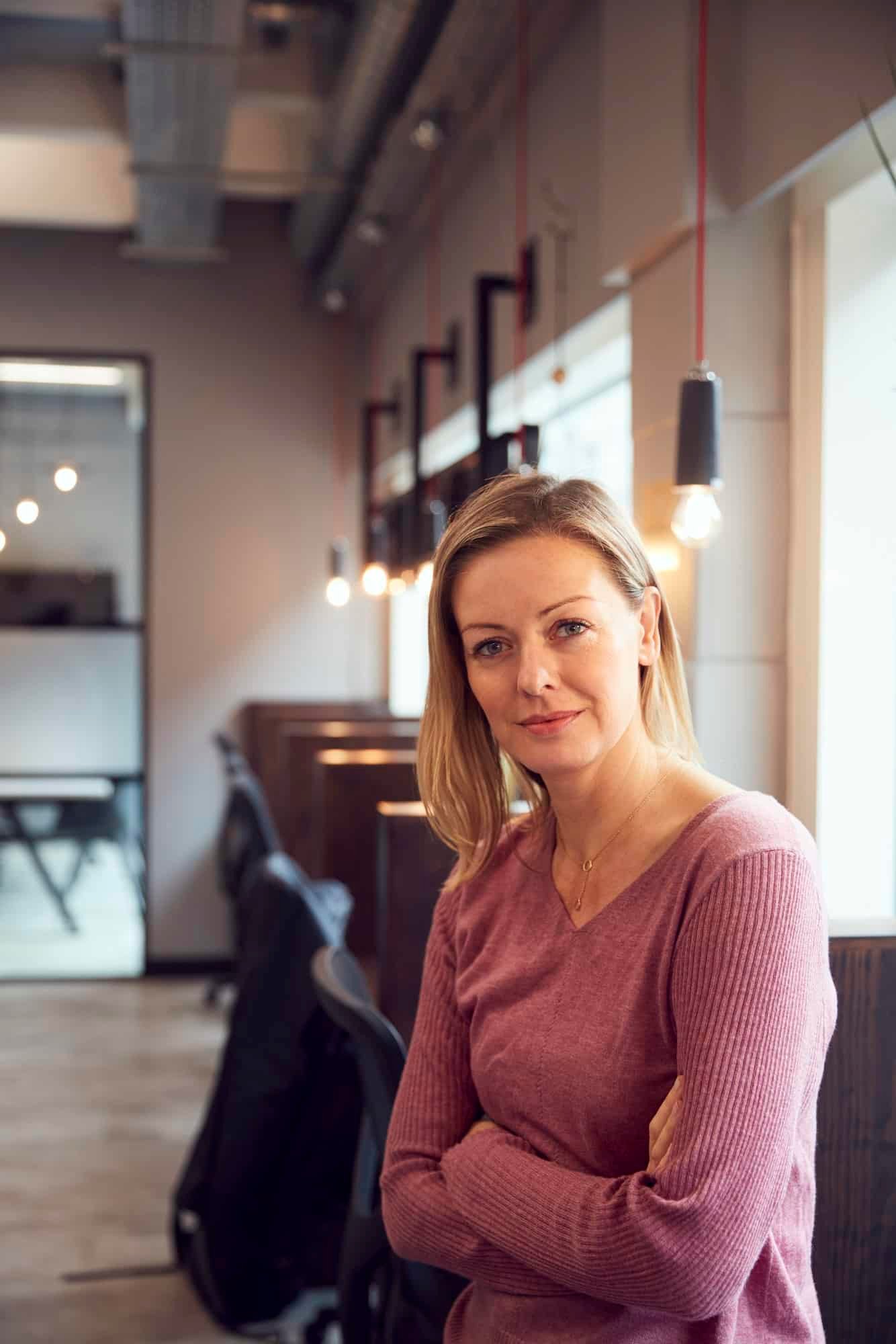 Head And Shoulders Portrait Of Mature Businesswoman Working In Modern Office