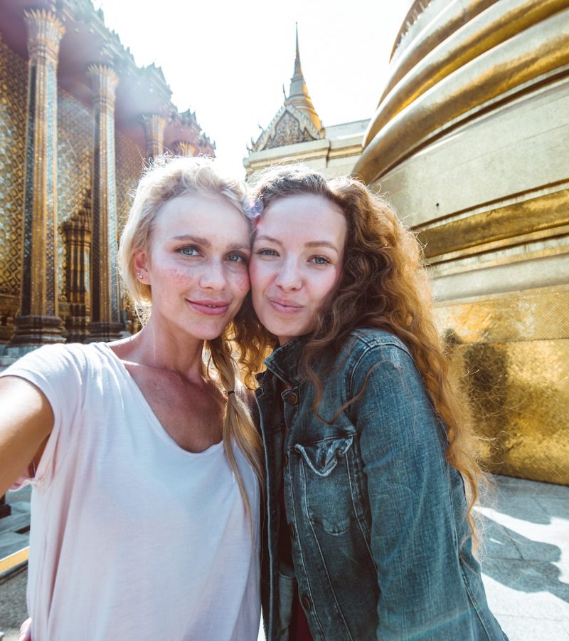Couple of beautiful girls visiting bangkok maining attractions