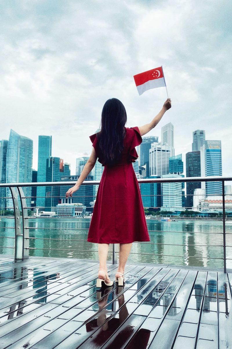 Girl In Red Dress Waving Singapore Flag
