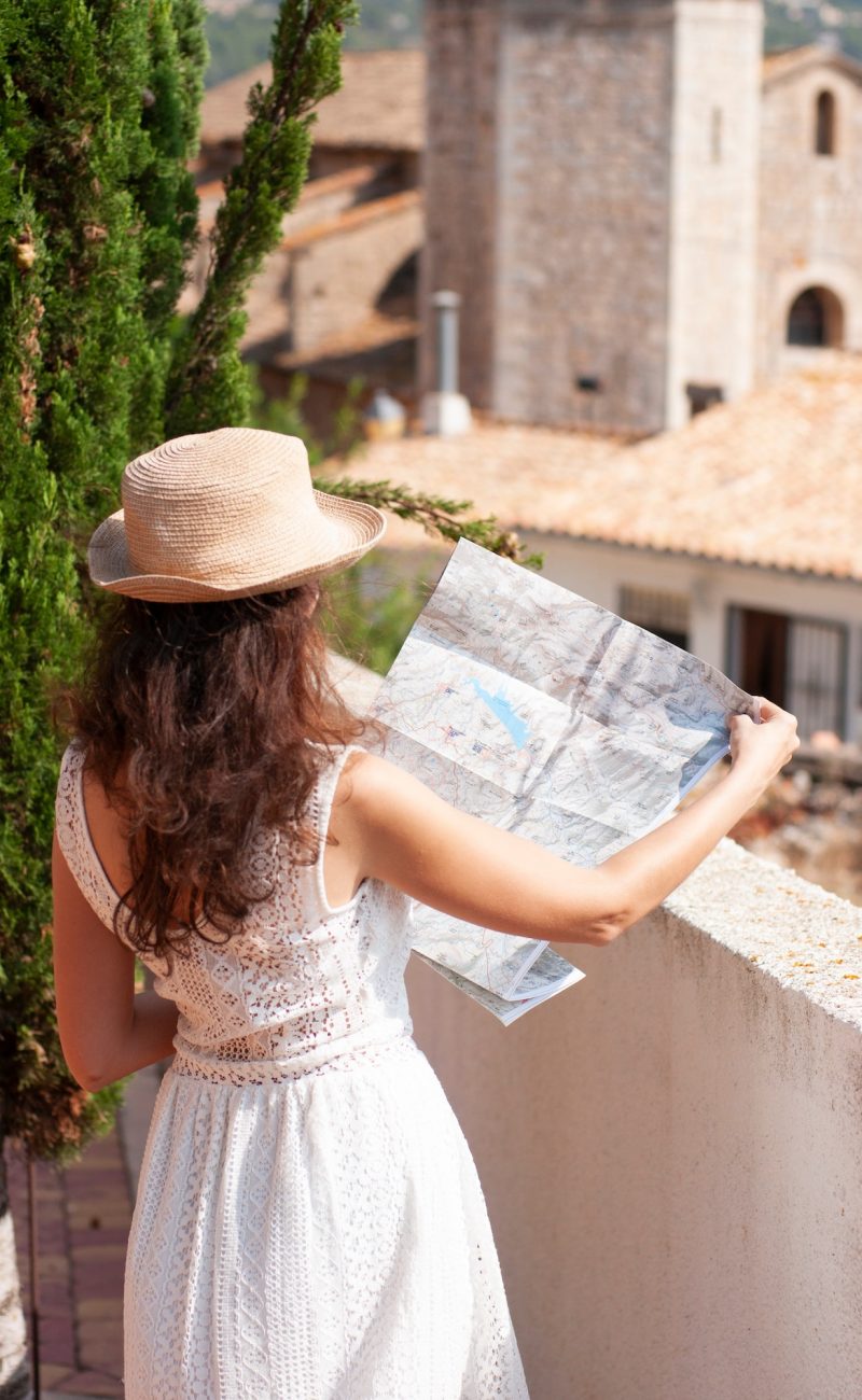 Girl looking at the map. Summer holidays in Spain. Traveler, tourist