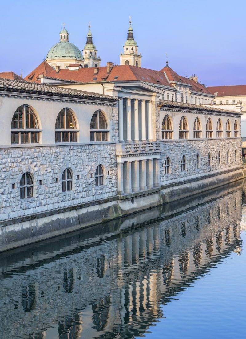 Ornate building reflected in river, Ljubljana, Central Slovenia, Slovenia