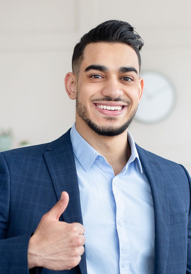 smiling-arab-businessman-holding-computer-showing-PAUEEHC.jpg