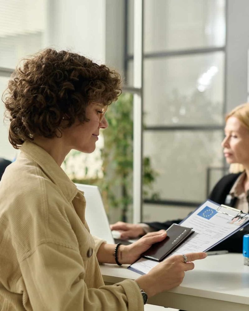 Smiling Young Woman Holding Approved Visa