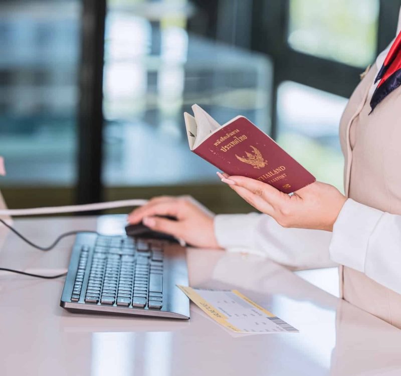 Thailand Travel Concept. Airline Officer Check In Ticket Tourist With Passport Visa Counter Service, Golden Visa Canada Consultancy