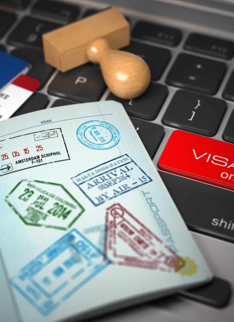 Visa Online Application Concept. Open Passport With Visa Stamps