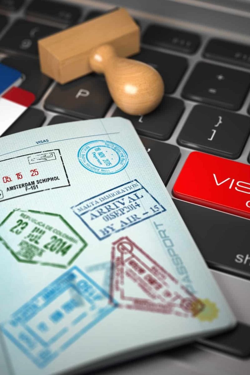 Visa Online Application Concept. Open Passport With Visa Stamps